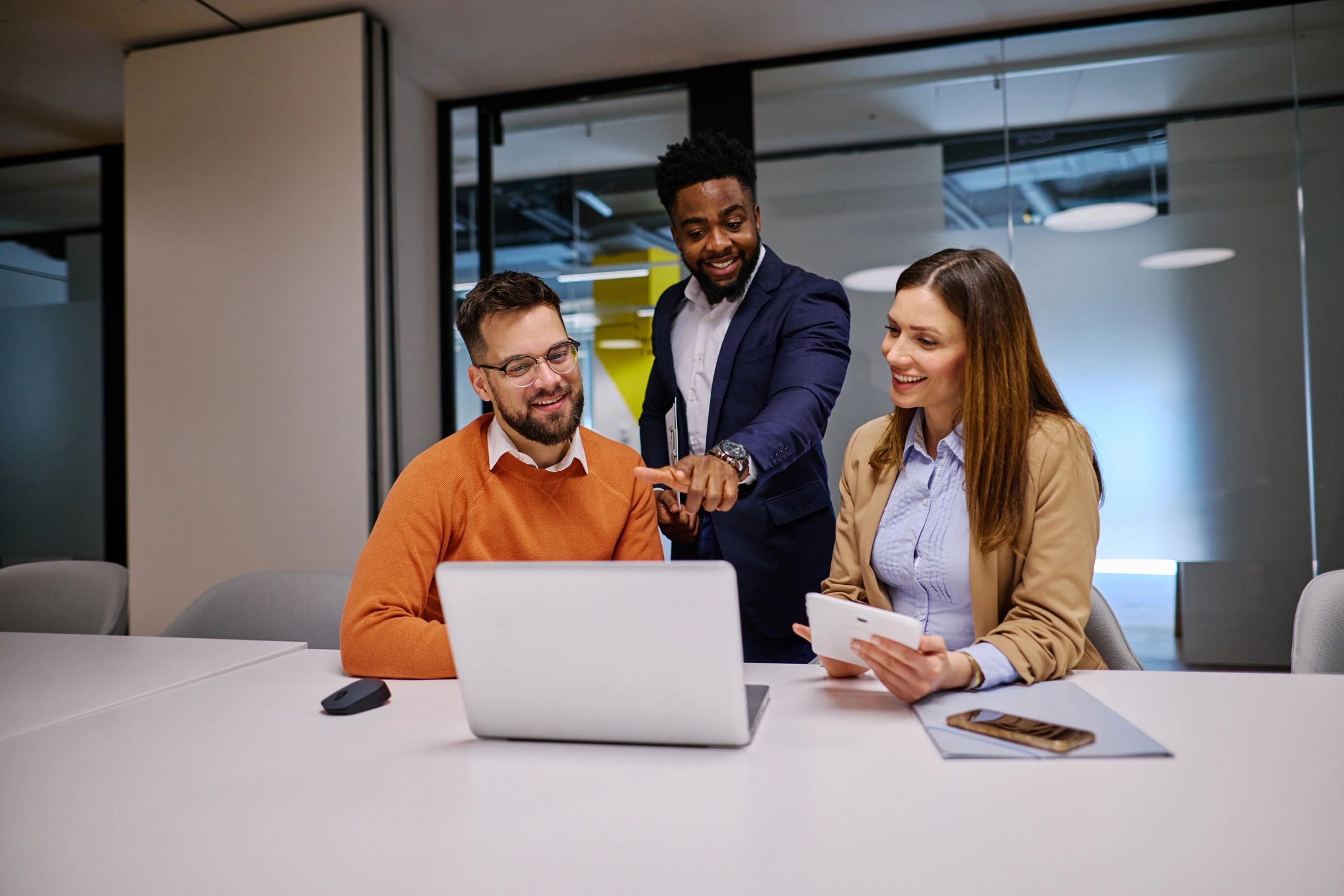 Agency team collaborating with laptop and tablet